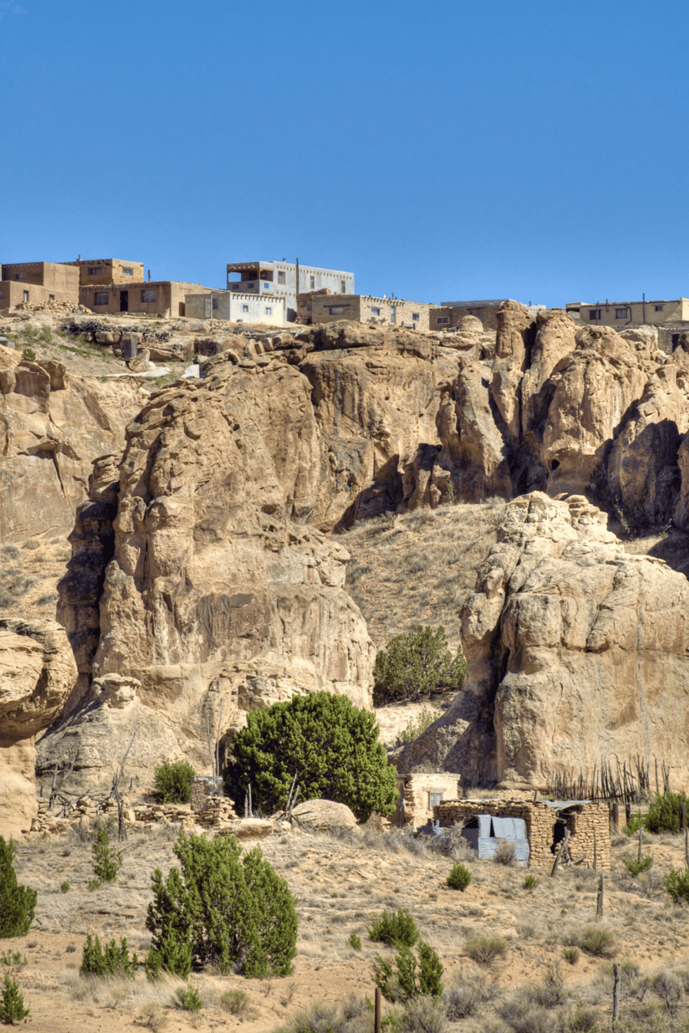 Ancient desert village built on rocky cliffs with unique architecture and rugged landscape.