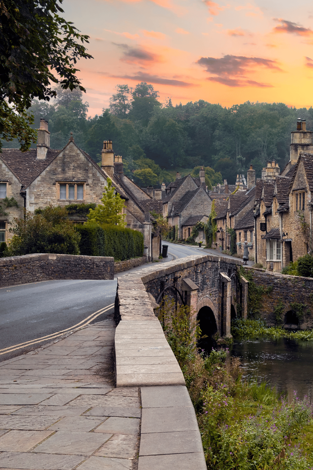Charming historic village with stone houses and a scenic bridge at sunset, perfect for exploring English countryside.