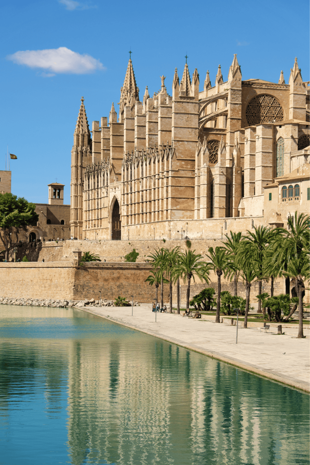 Majestic Gothic cathedral with historical architecture and scenic waterfront view.