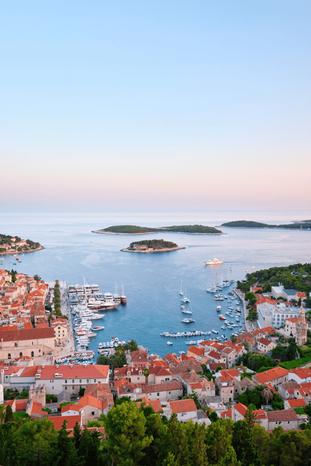 Harbor with yachts and historic coastal town, scenic sea views, popular travel destination, Croatia.