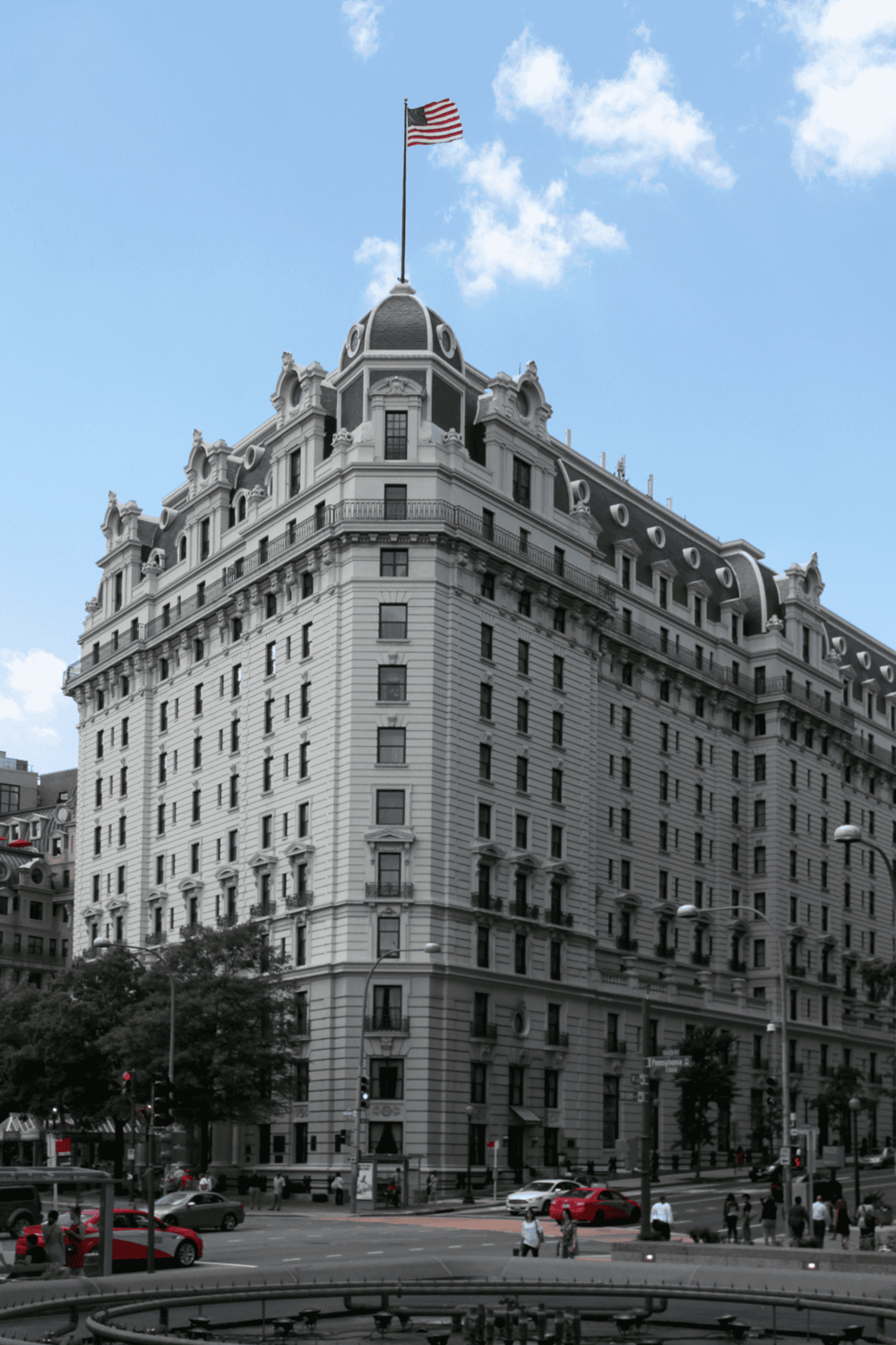 Luxury historic building with American flag in downtown cityscape, architectural elegance and urban vibe.