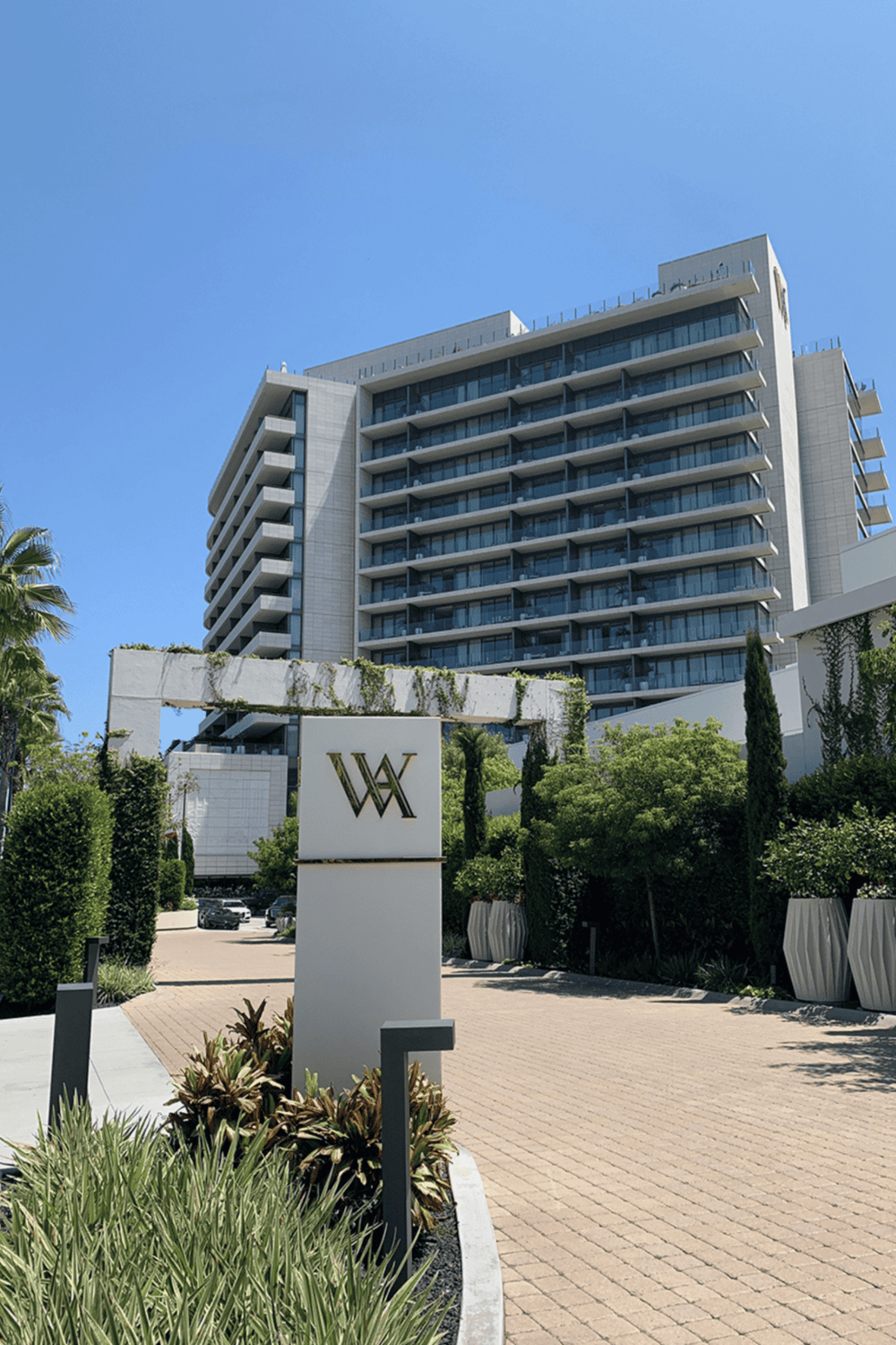 Contemporary luxury apartment building with modern architecture and lush landscaping.