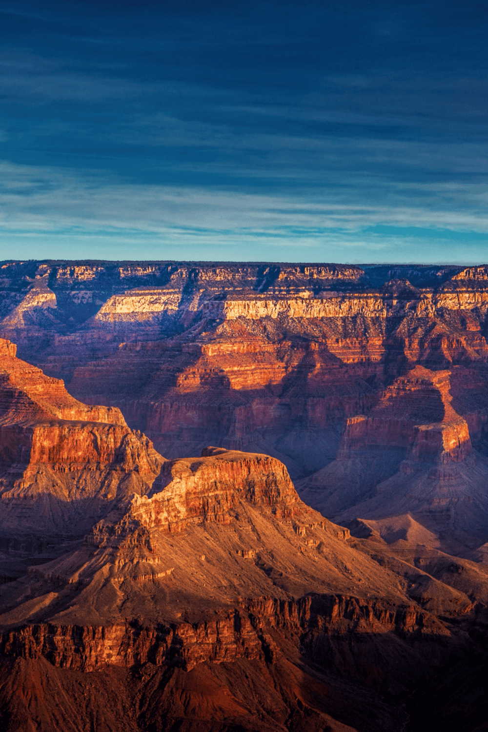 Vibrant Grand Canyon landscape with layered red rocks and dramatic cliffs, showcasing natural beauty and breathtaking scenery.