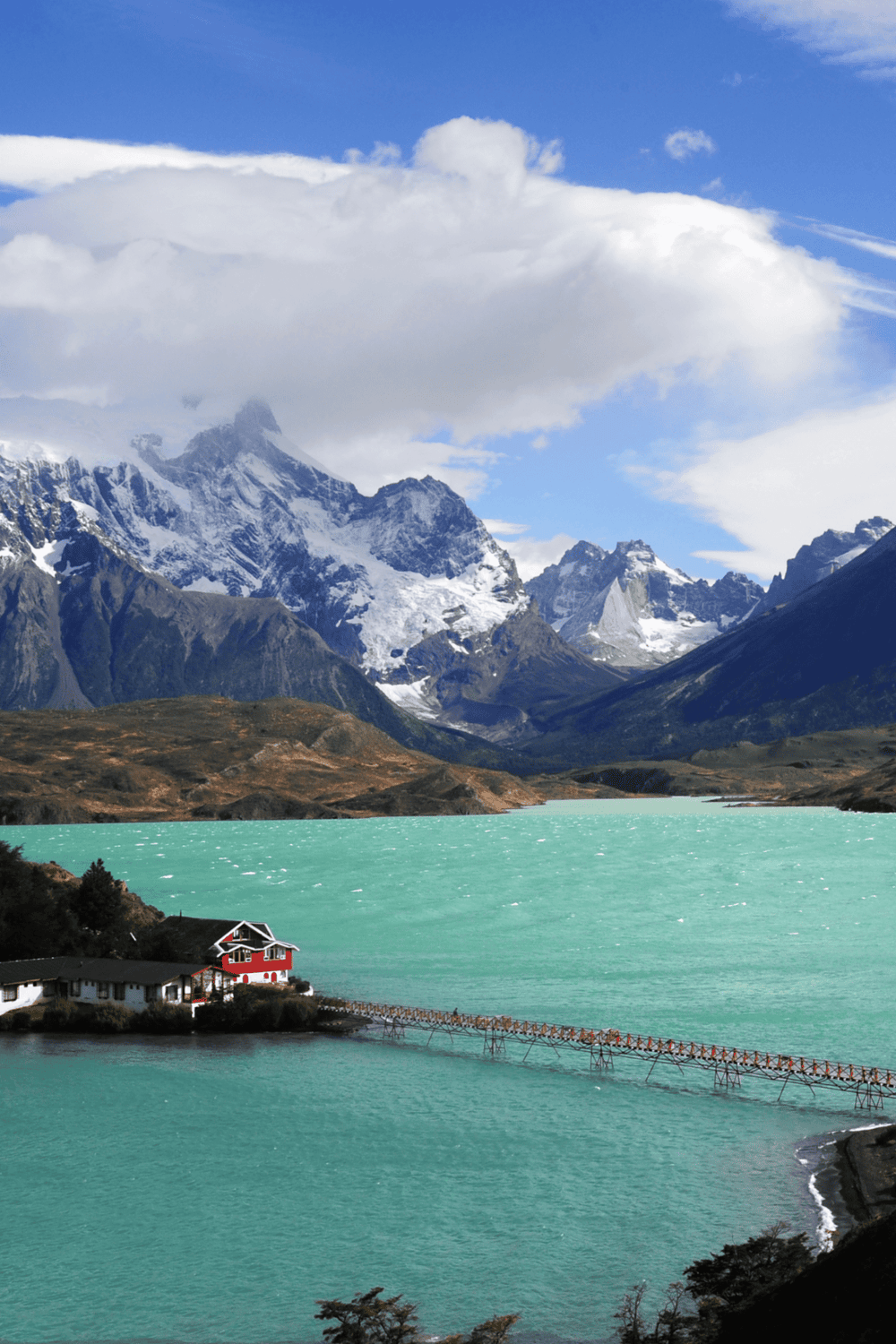 Magnificent mountain landscape with snow-capped peaks and turquoise lake at QuestForDirections.