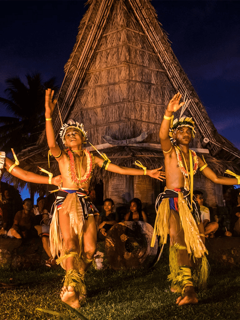 Traditional Polynesian dancers performing at a cultural event for tourism promotion.