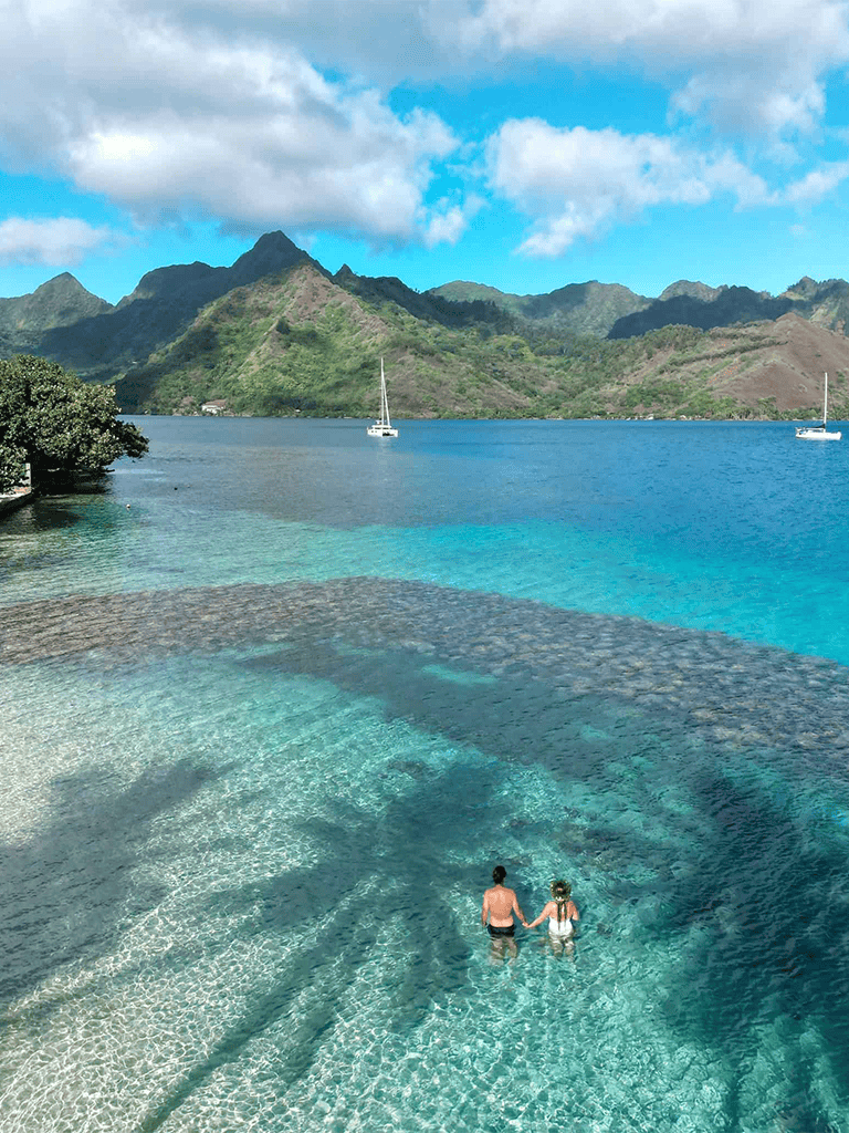 Crystal clear ocean water and mountain scenery at a tropical destination.