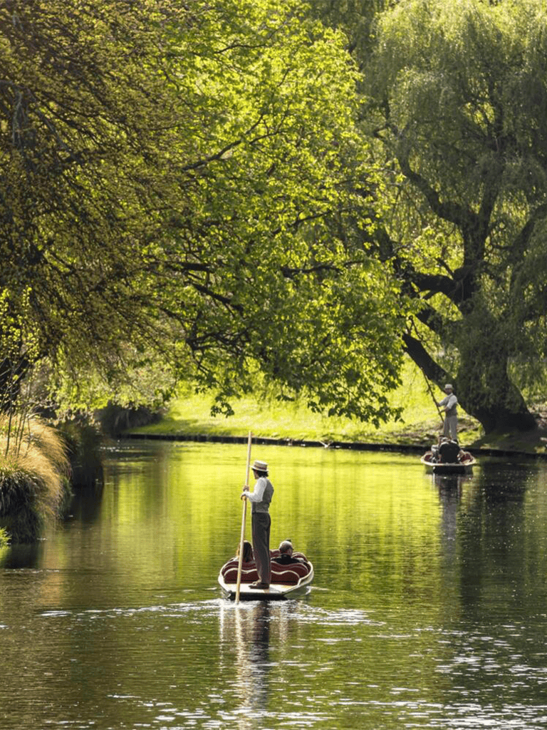 Peaceful paddle boat tour on a lush green river with guides, perfect for nature and outdoor activity enthusiasts.