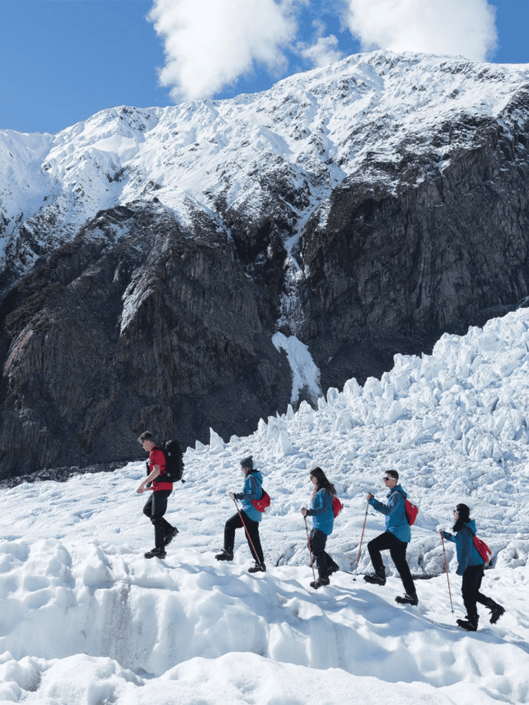 Alpine mountain expedition with hikers trekking through snow and ice in breathtaking glacier scenery.