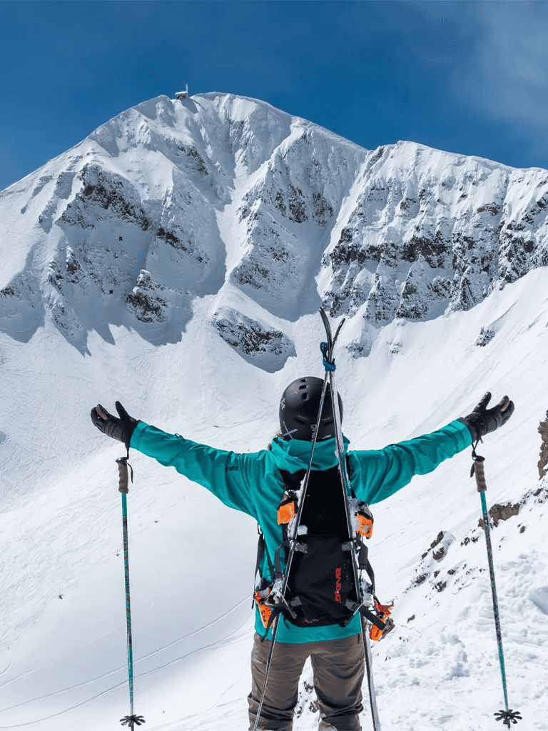 1. Snowy mountain climbing adventure with skier in alpine landscape.