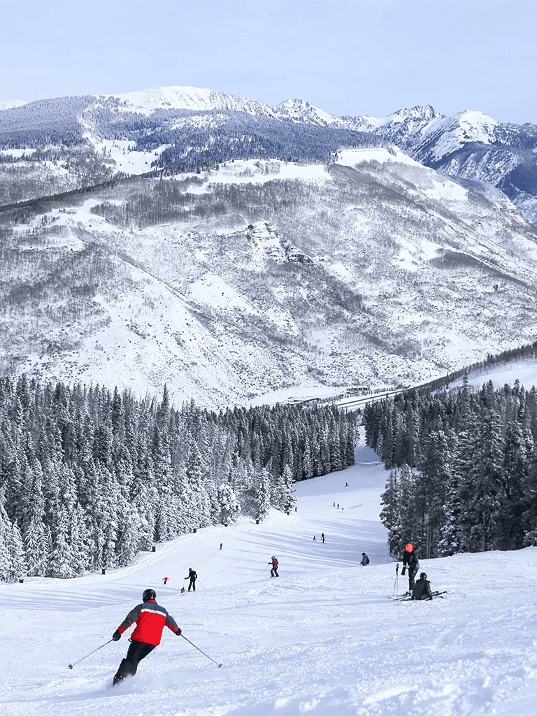 Snowy mountain ski resort with skiers enjoying winter sports in the mountains.