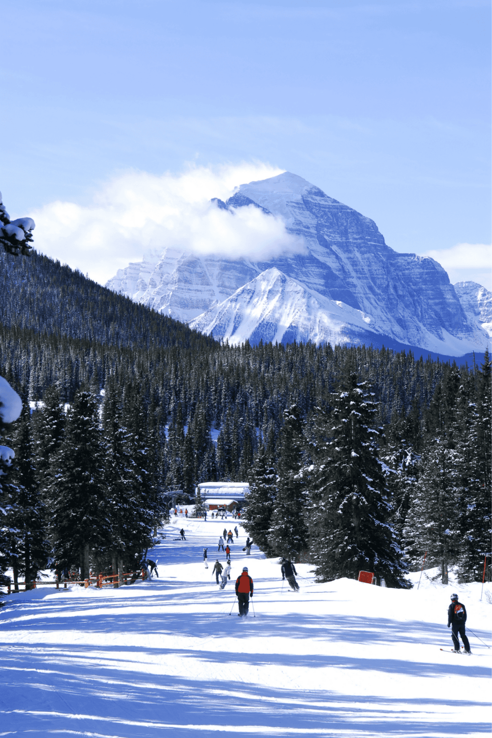 Snow-covered mountain landscape with skiers and snowboarders at QuestForDirections.