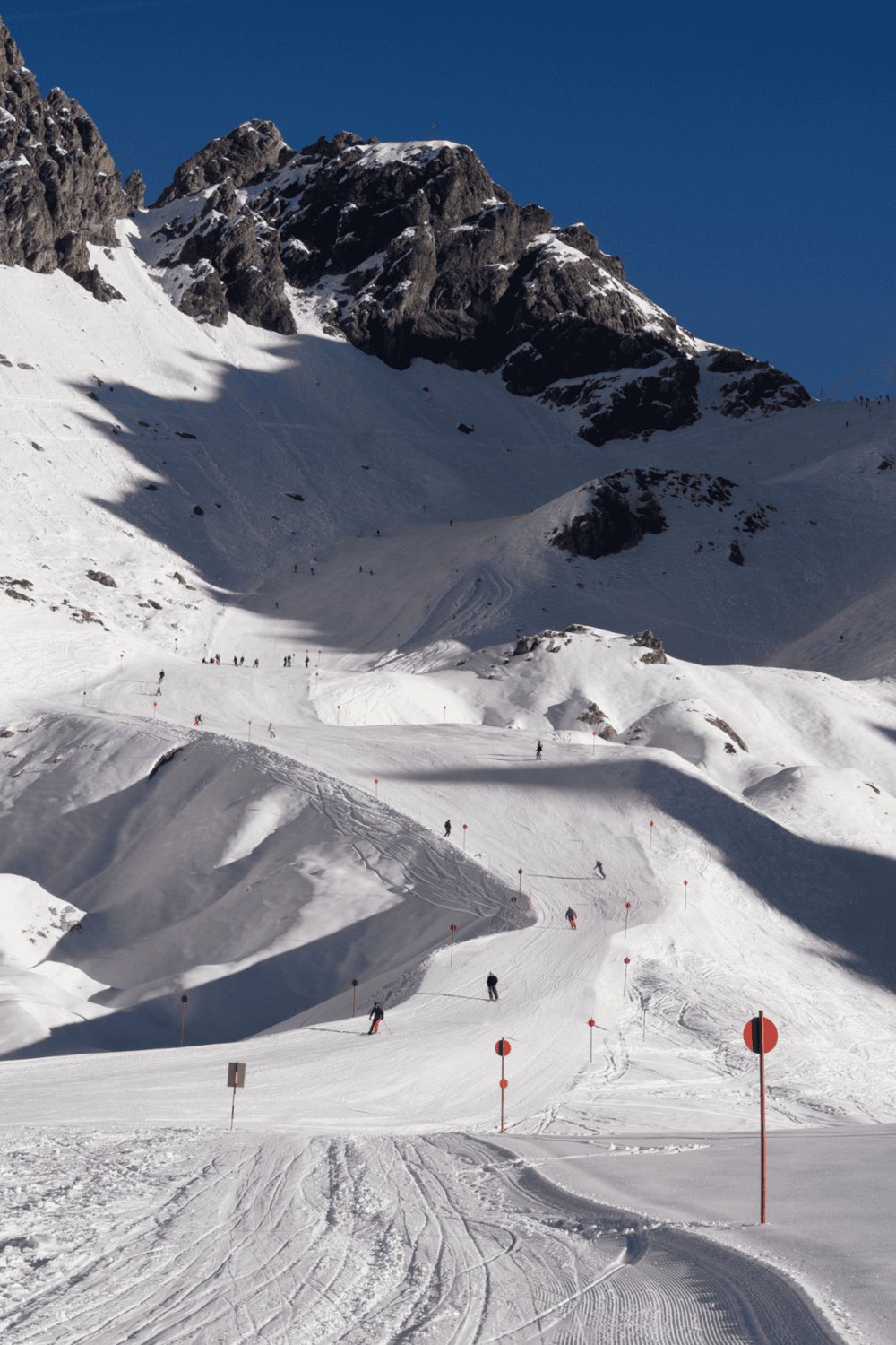 Snowy mountain ski slope with skiers, ideal for winter sports and mountain adventures.