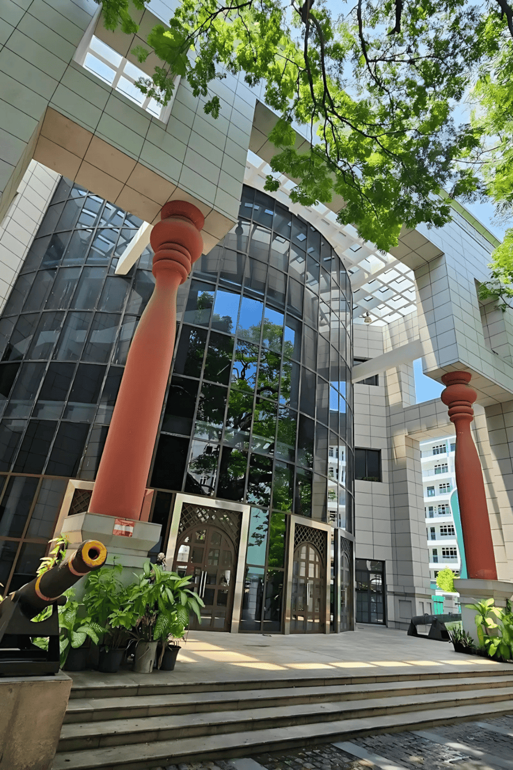 Modern urban building with glass facade and architectural details.