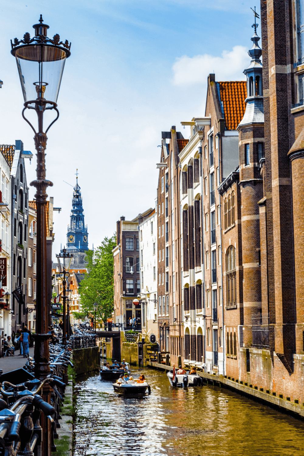 Picturesque canal in Amsterdam showcasing historic architecture and vibrant city life.