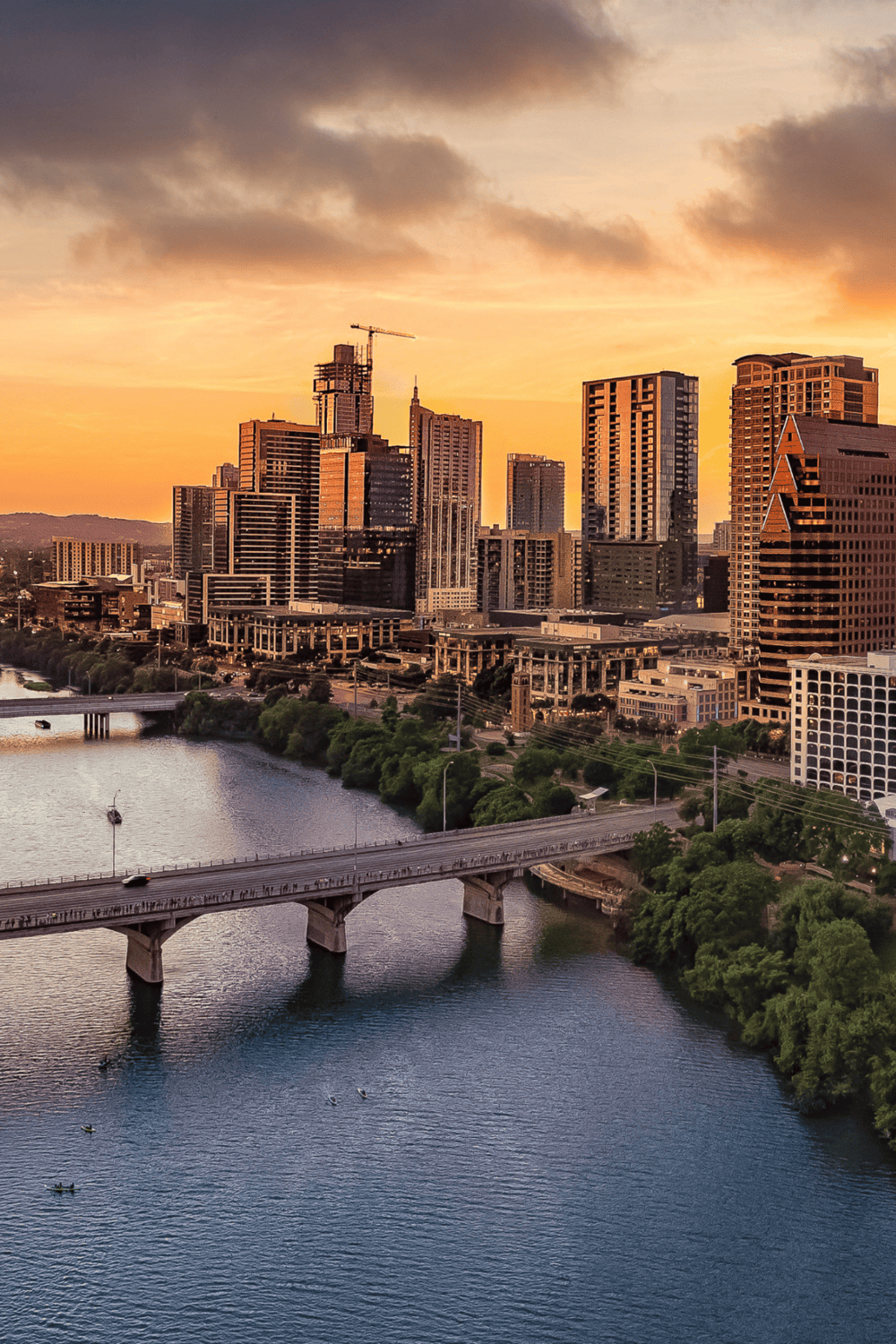 City skyline at sunset with skyscrapers and a river, vibrant urban landscape for Directional Navigation SEO.