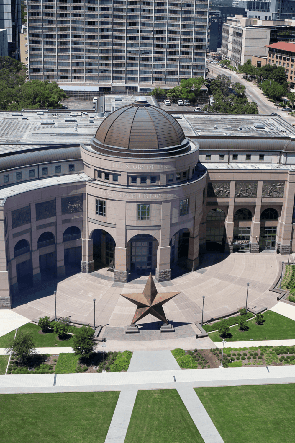 Historic Texas State History Museum in Austin, featuring iconic star monument and modern cityscape.