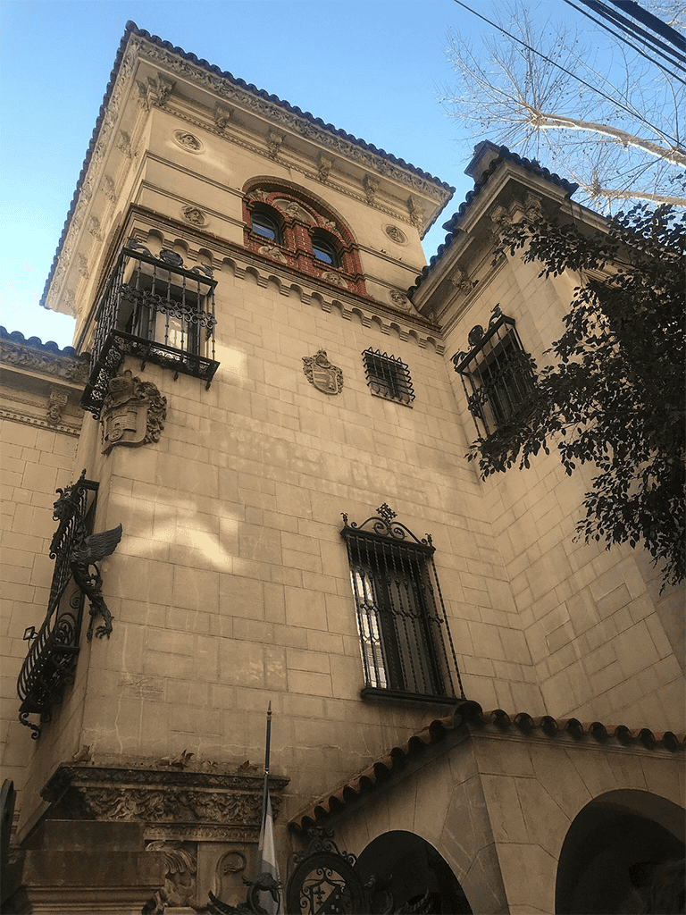 Elegant historic Spanish-style building with ornate details and iron balconies.