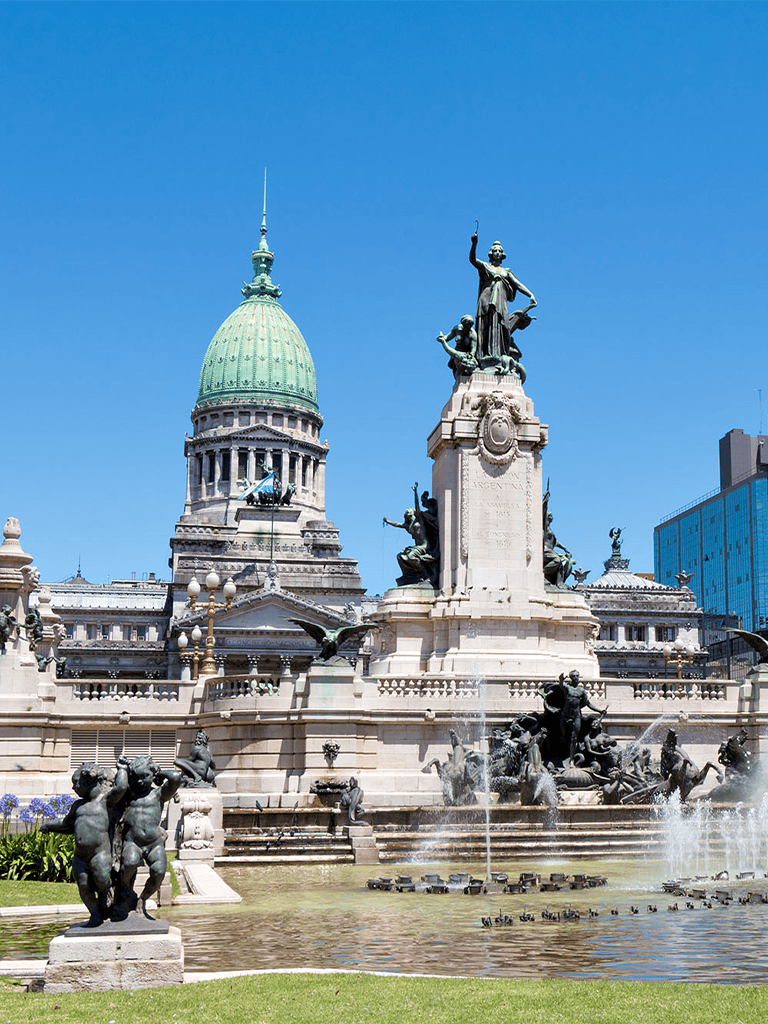 Historic Argentine National Congress building with ornate bronze statues and fountain in Buenos Aires.