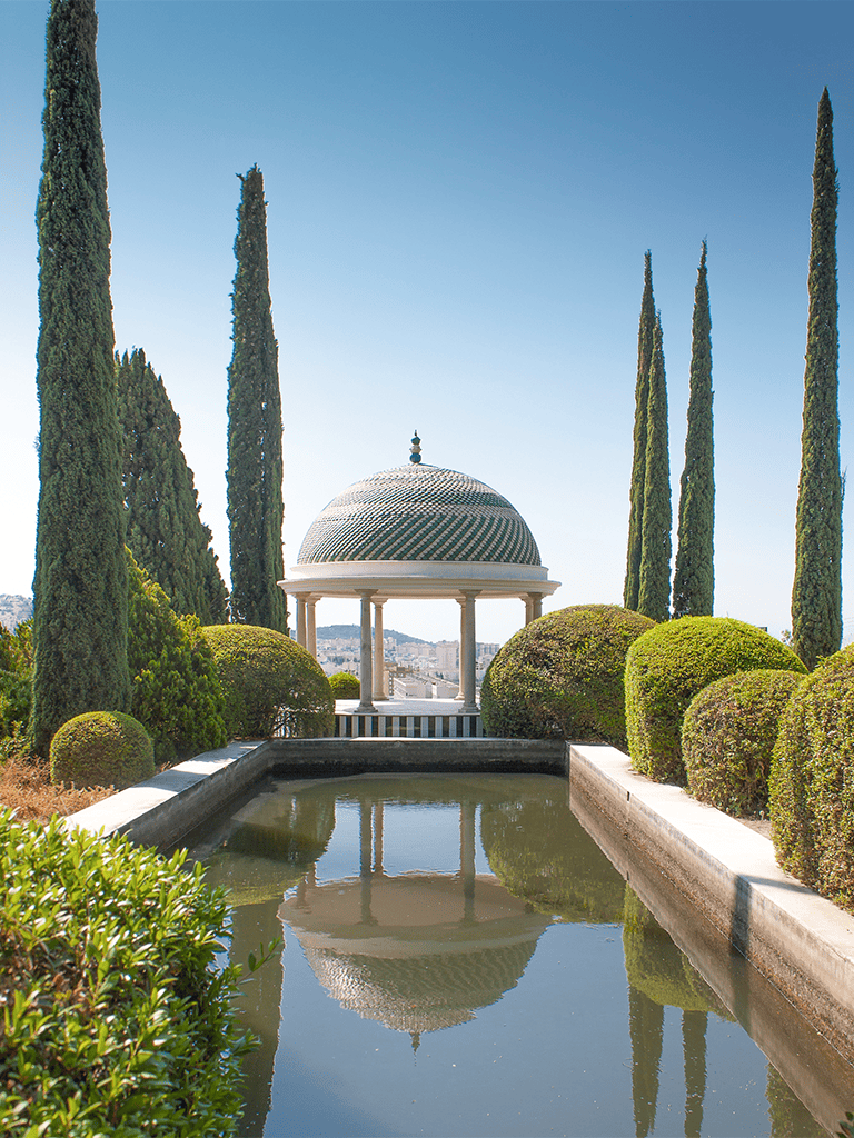 Serene garden with domed gazebo, cypress trees, and reflecting pond at QuestForDirections.