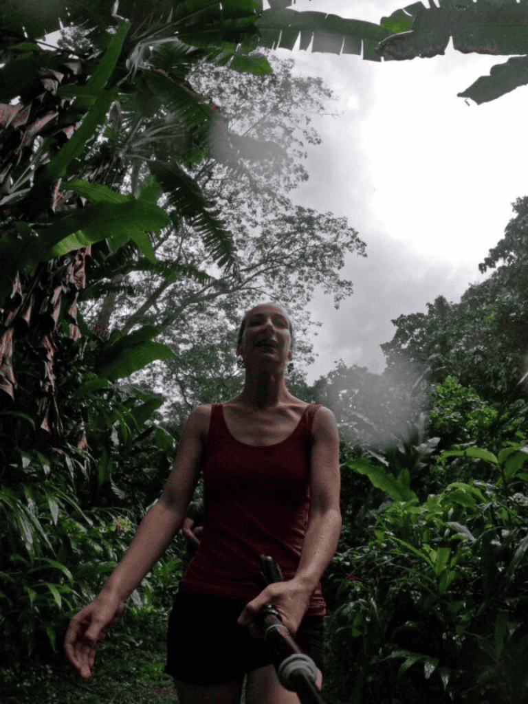 Enjoying a jungle hike using QuestForDirections navigation app in lush tropical rainforest.