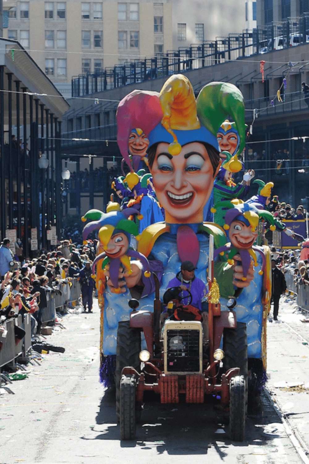 Colorful parade float with jester costume, festive event, city parade, vibrant carnival celebration.