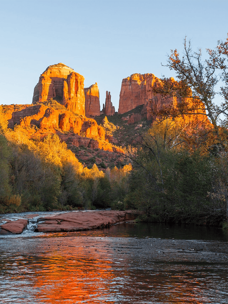 Vibrant red rock formations in Sedona, Arizona during autumn sunset, popular for scenic adventures and hiking.