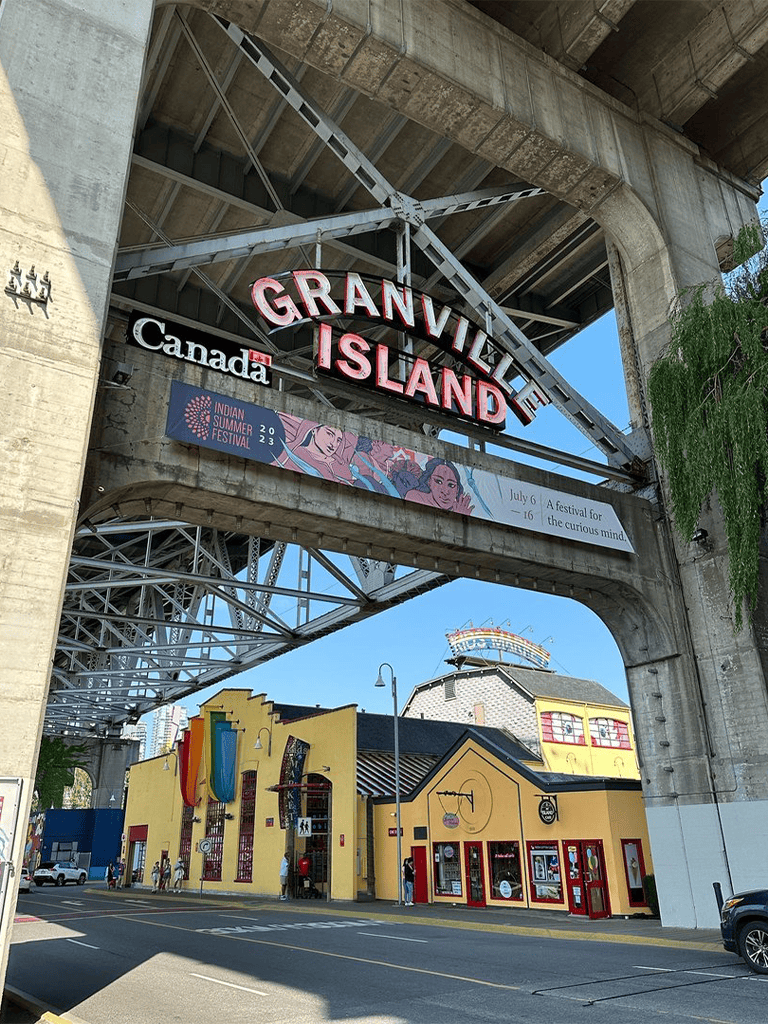 Grandville Island sign under historic bridge, Vancouver attractions, travel guide, Canada travel destination, cultural hotspots.
