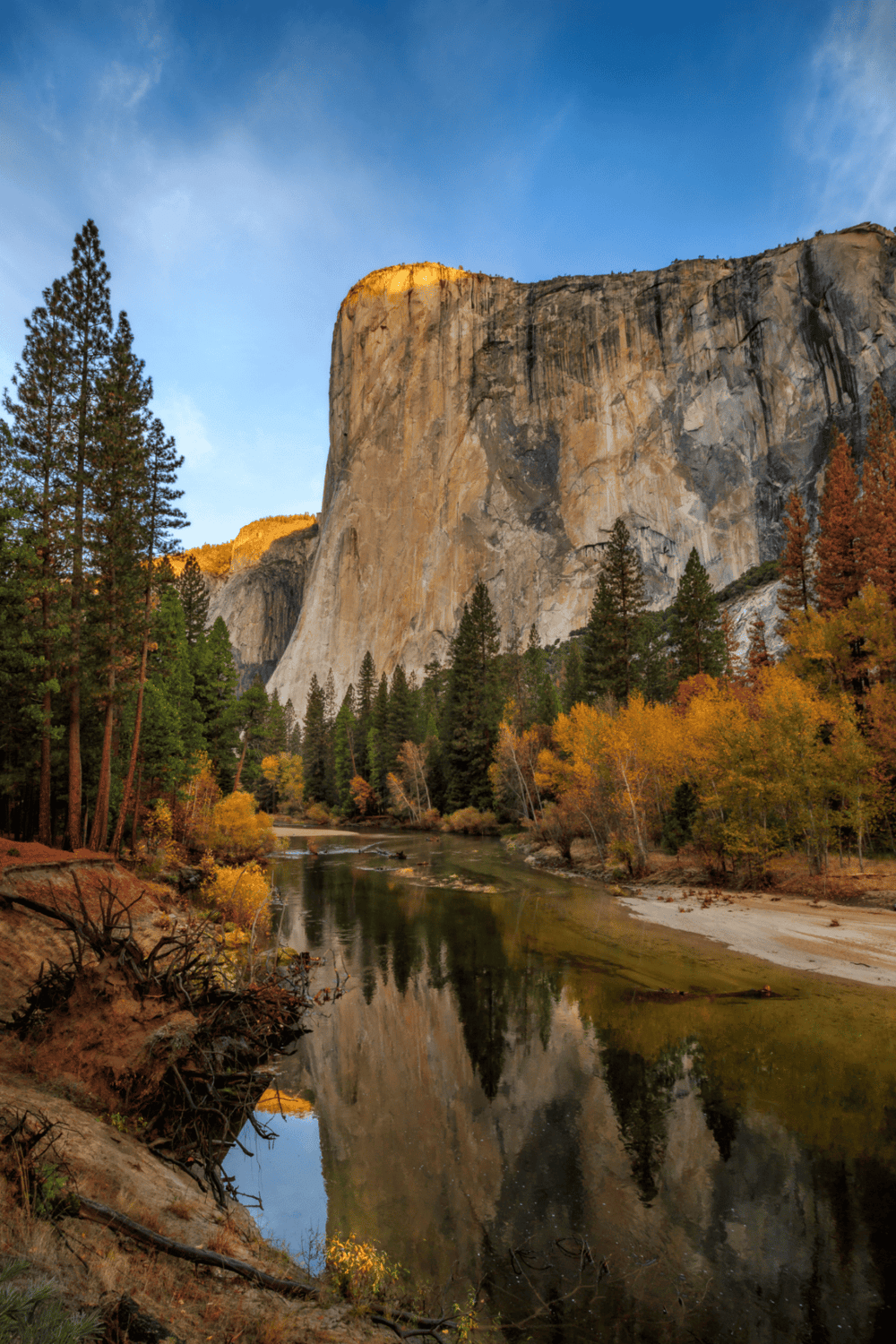 Majestic Yosemite Valley with towering granite cliffs and colorful autumn trees, a serene spot in national parks.