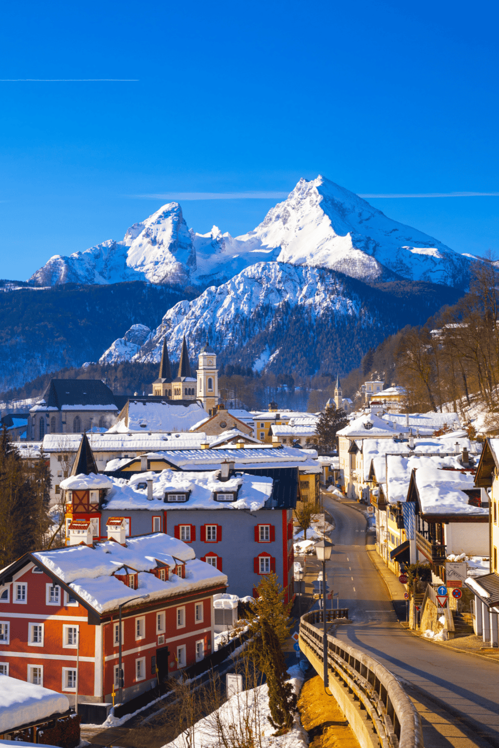 Snow-capped mountain village in the Alps with colorful buildings and scenic landscape.