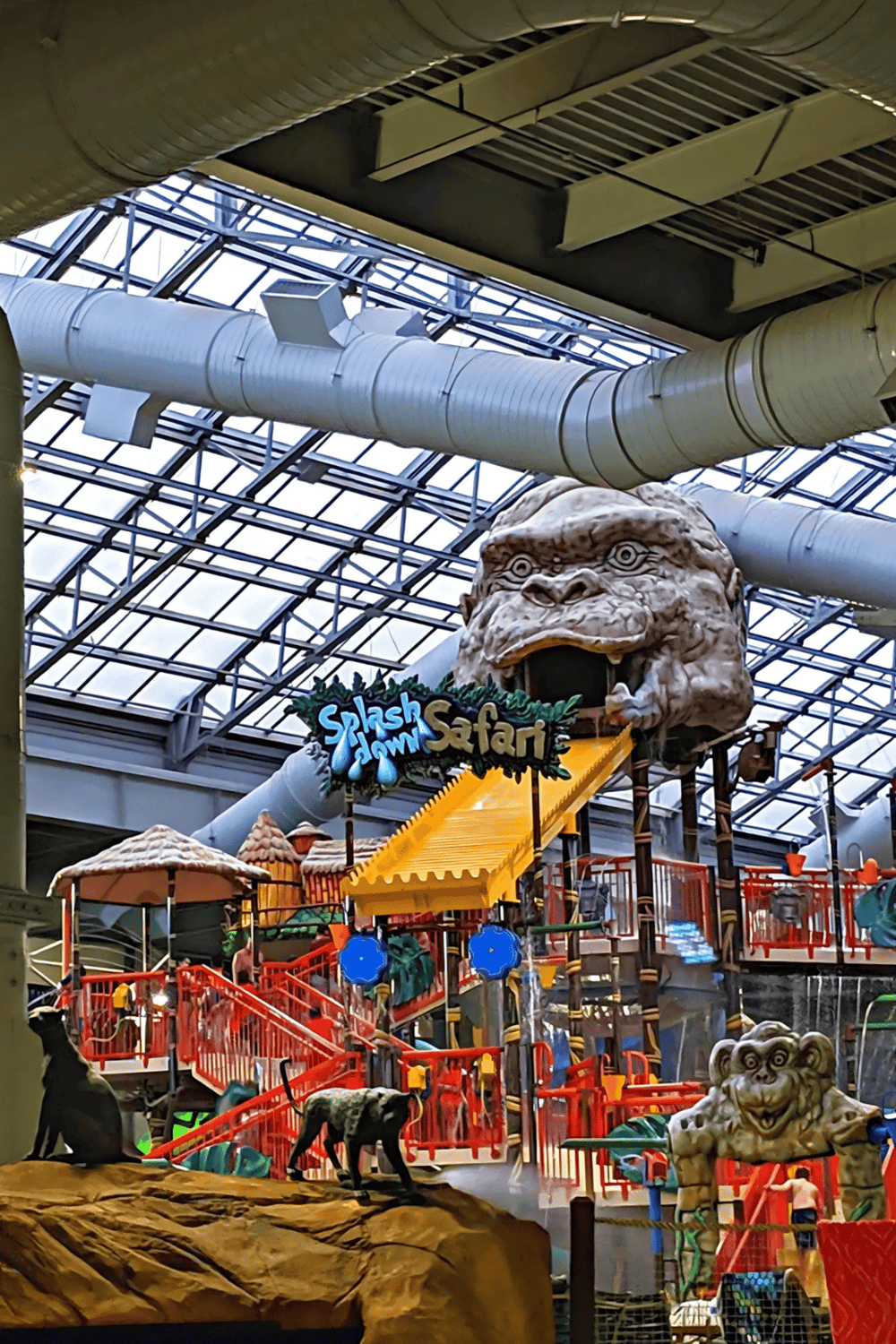 1. Indoor water park ride with jungle-themed decor and animal sculptures.