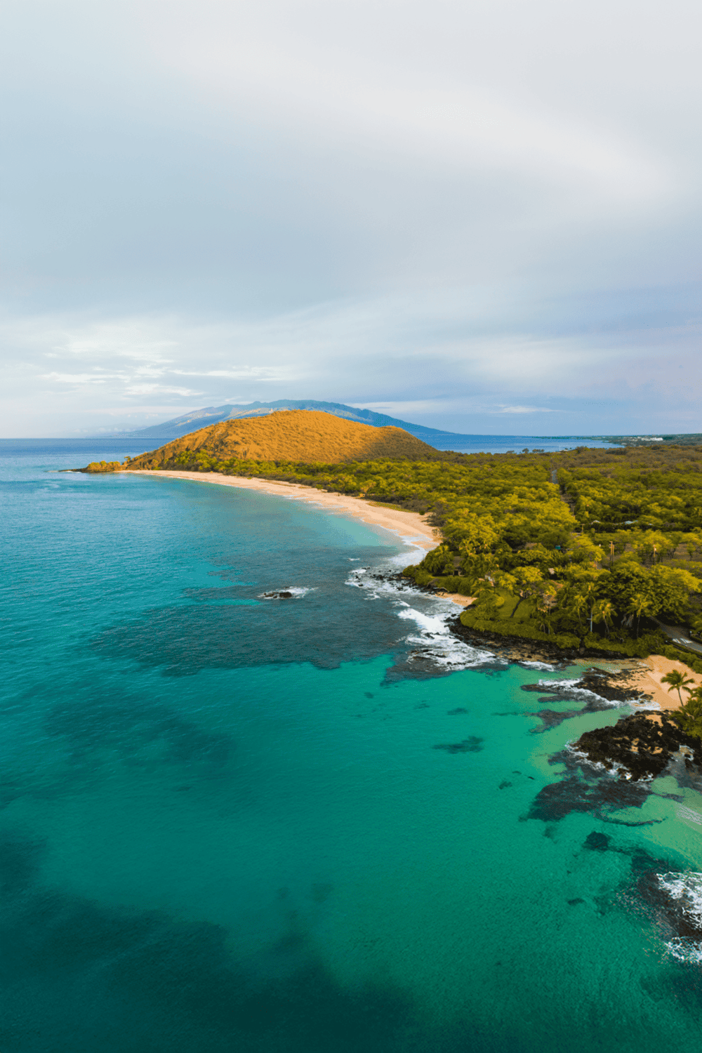 Vibrant tropical beach with clear turquoise water and lush green surroundings, ideal for travel and adventure.