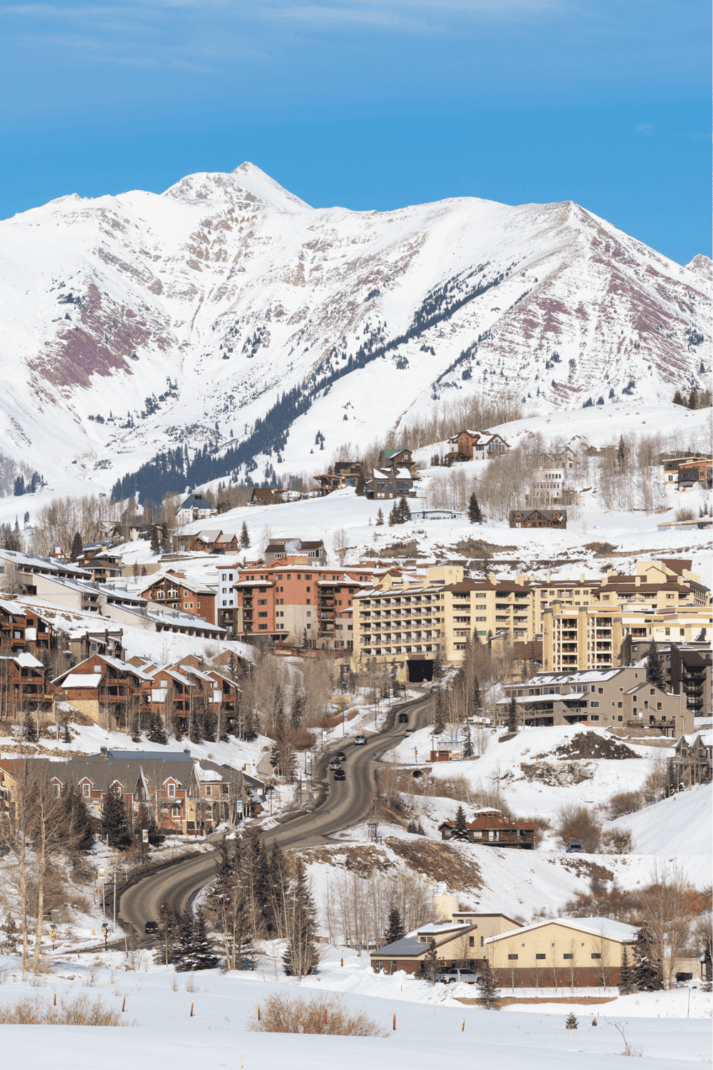 Snow-covered mountain village with ski resort amenities and scenic alpine views.