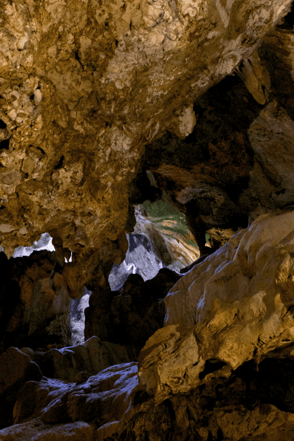 Mysterious underground cave with rugged rock formations and natural lighting.