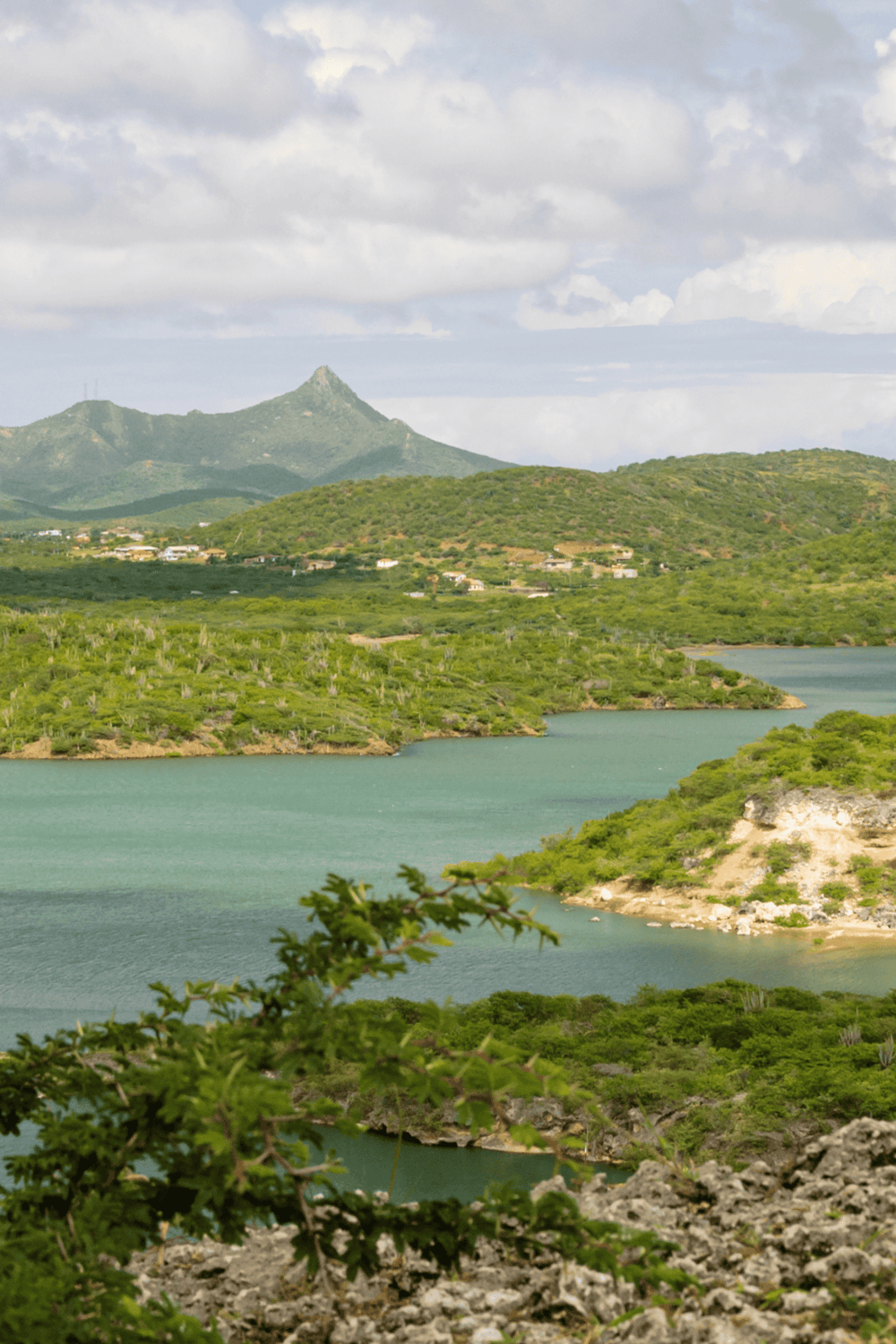 Serene landscape with mountains, lush greenery, and water, perfect for adventure and travel planning.