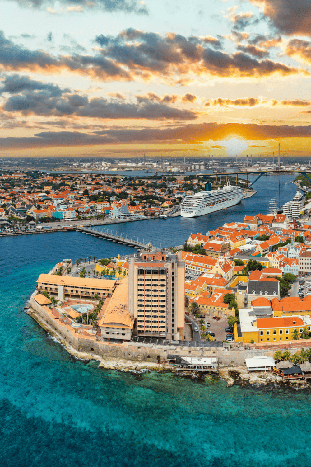 Scenic harbor view of Willemstad, Curaçao with colorful Dutch colonial buildings and cruise ships.