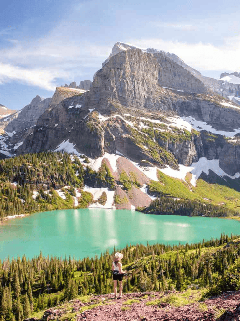 Majestic mountain landscape with turquoise lake and lush greenery, perfect for adventure travel and outdoor exploration.