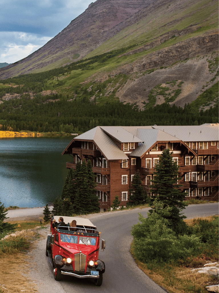 Scenic mountain resort with lake, wooden building, and vintage car for travel and adventure.