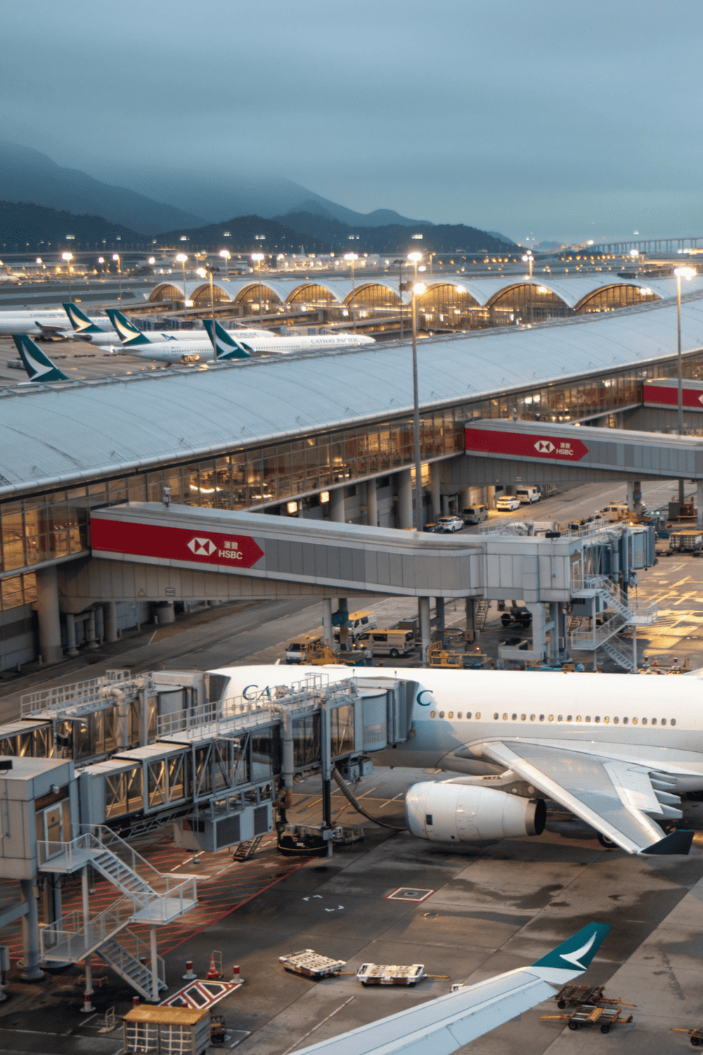 Airports with airplanes and modern terminal buildings at dusk, travel and transportation hub, QuestForDirections SEO imagery.