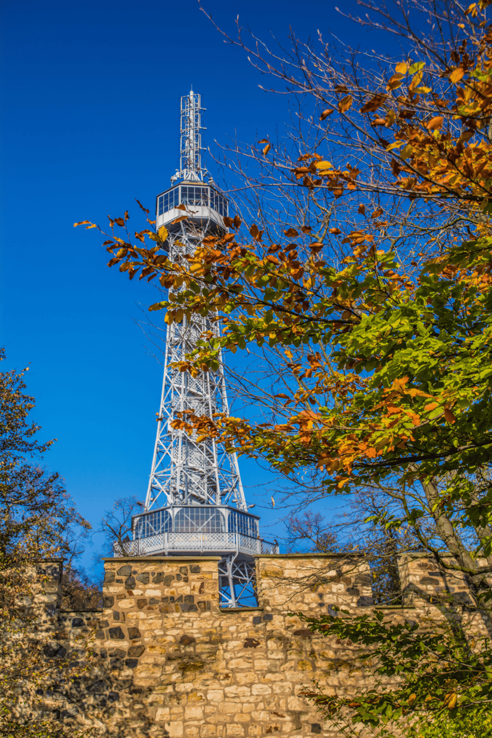 1. Tall observation tower with autumn trees and blue sky in the background.