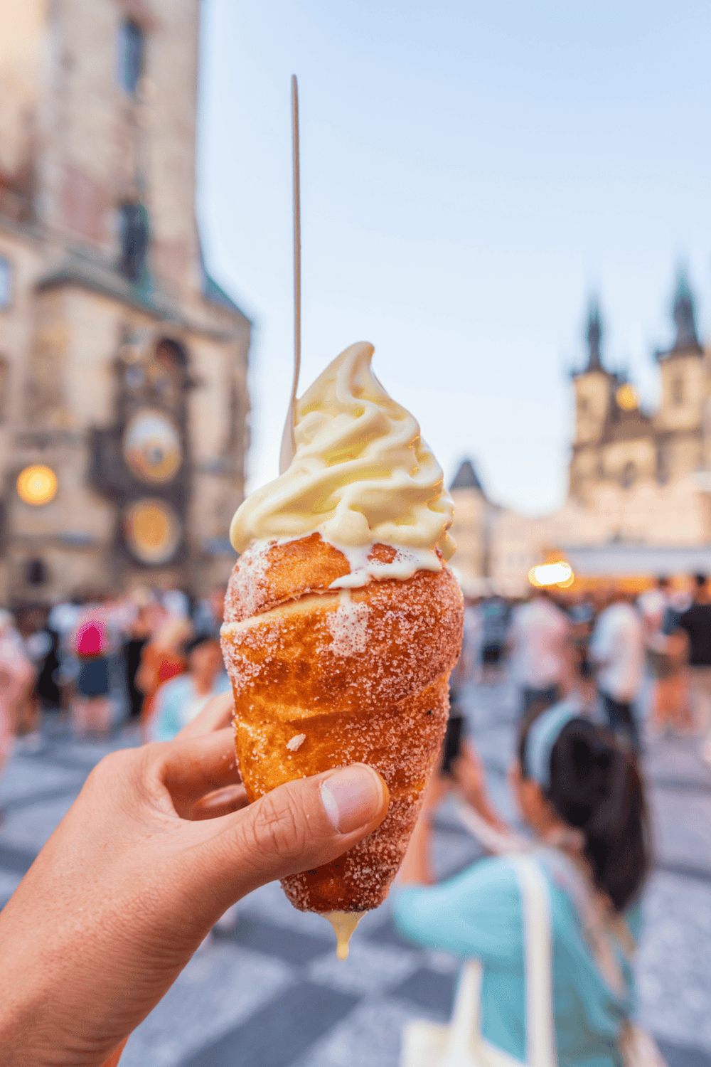Delicious street food ice cream cone in Prague’s Old Town Square, on warm summer evening.