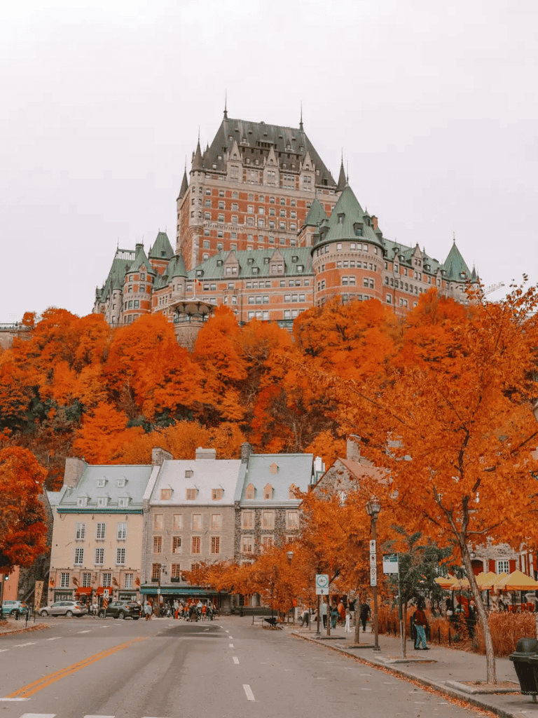 Grand Hotel Château Frontenac in Quebec City with vibrant autumn foliage.
