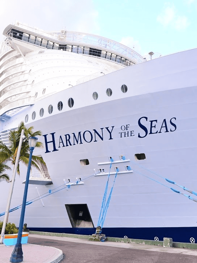 Luxurious cruise ship Harmony of the Seas docked at port, symbolizing luxury and adventure.