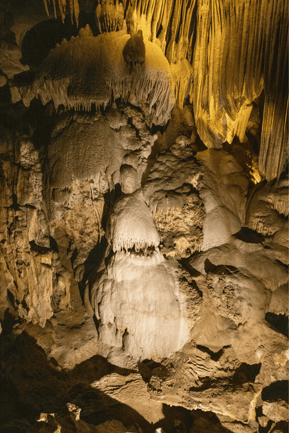 Intricate cave formations and stalactites in a scenic underground cavern.