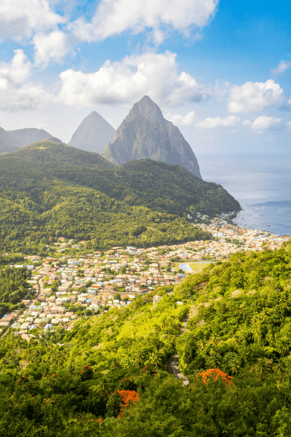 Vibrant Saint Lucia mountain scenery with lush greenery and coastal town view.