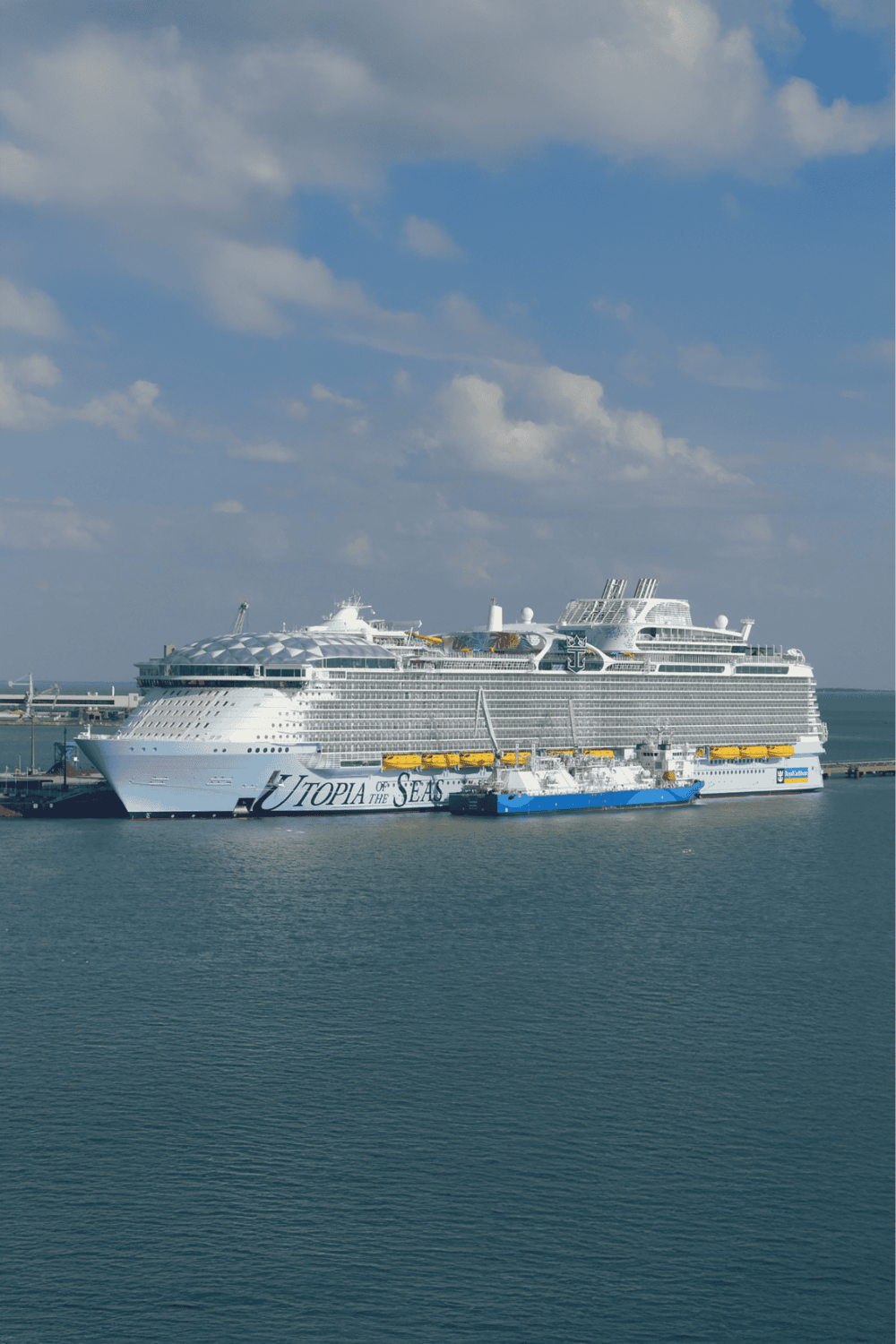 Luxury cruise ship docked at port featuring QuestForDirections branding for travel navigation.