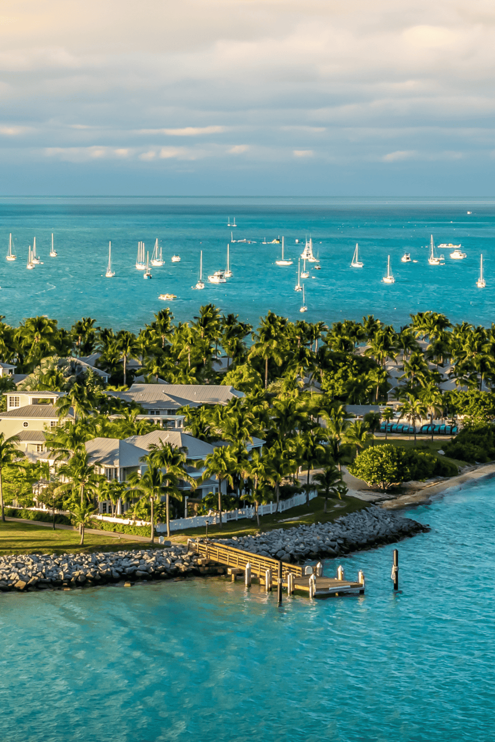 Luxurious coastal resort with palm trees, boats, and turquoise waters at Quest for Directions.