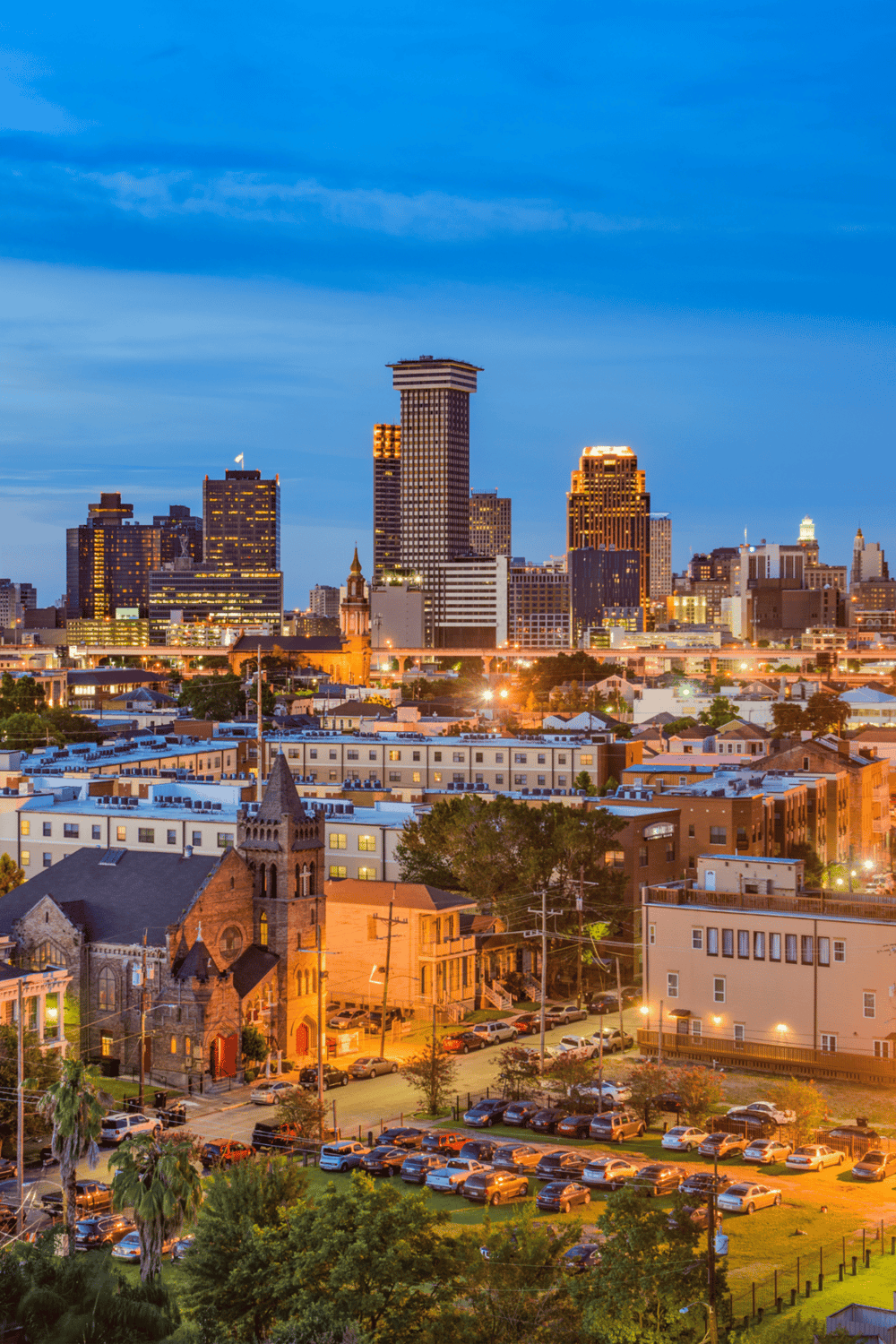 Vibrant city skyline view of downtown with illuminated buildings at dusk, showcasing urban nightlife and architecture.