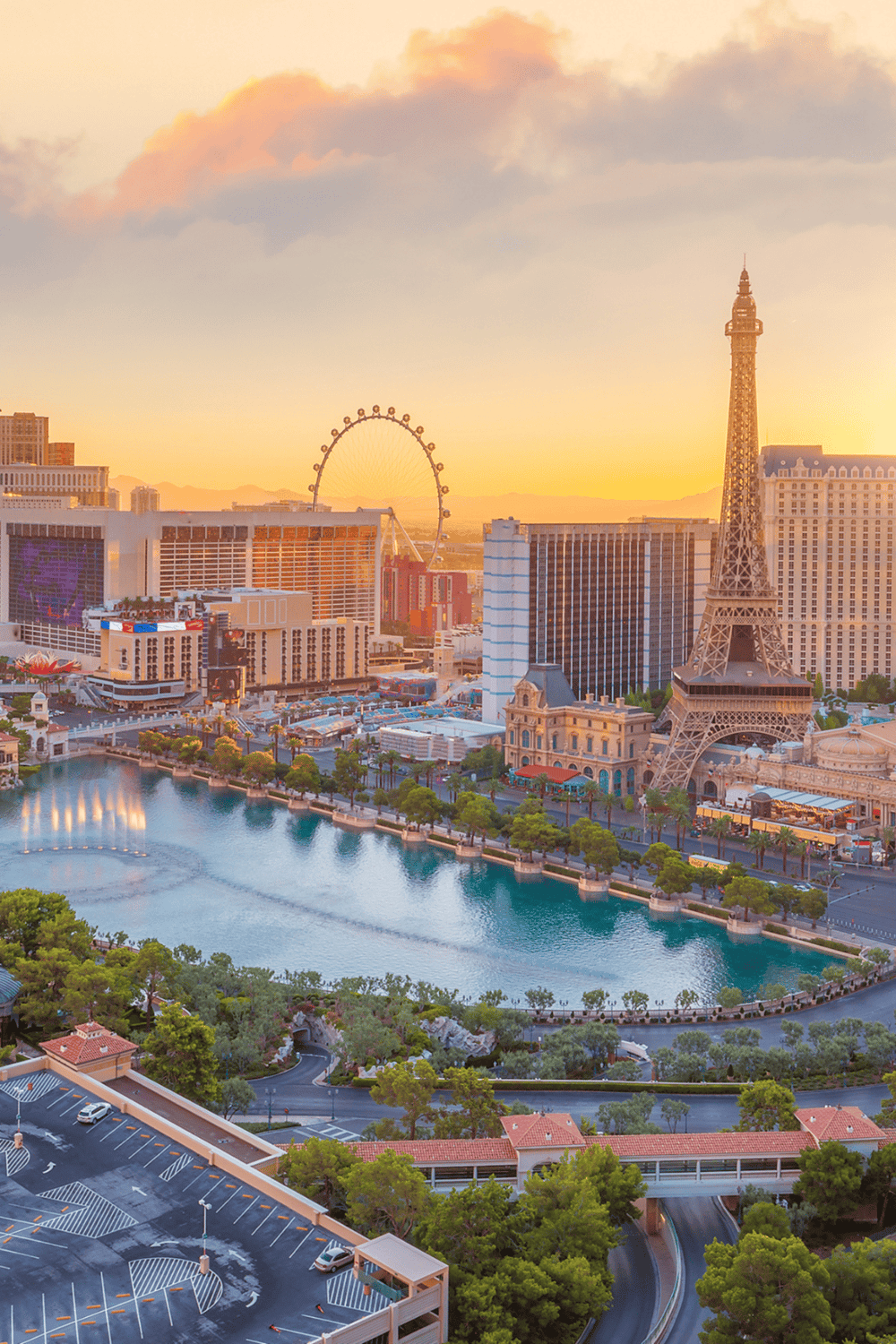 Las Vegas skyline with Eiffel Tower replica and high roller Ferris wheel at sunset.