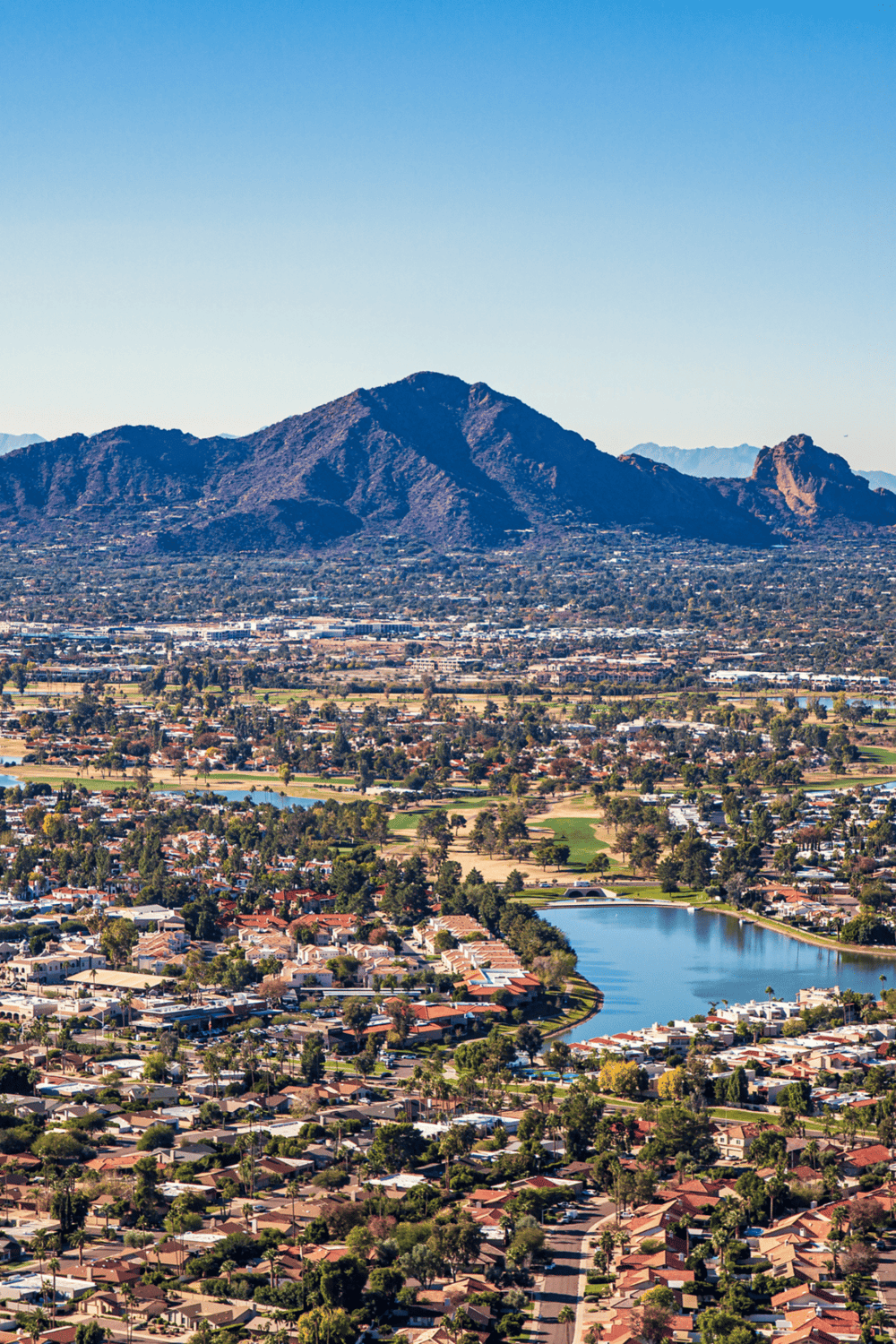Panoramic view of Scottsdale, Arizona with Camelback Mountain, residential neighborhoods, and golf courses.