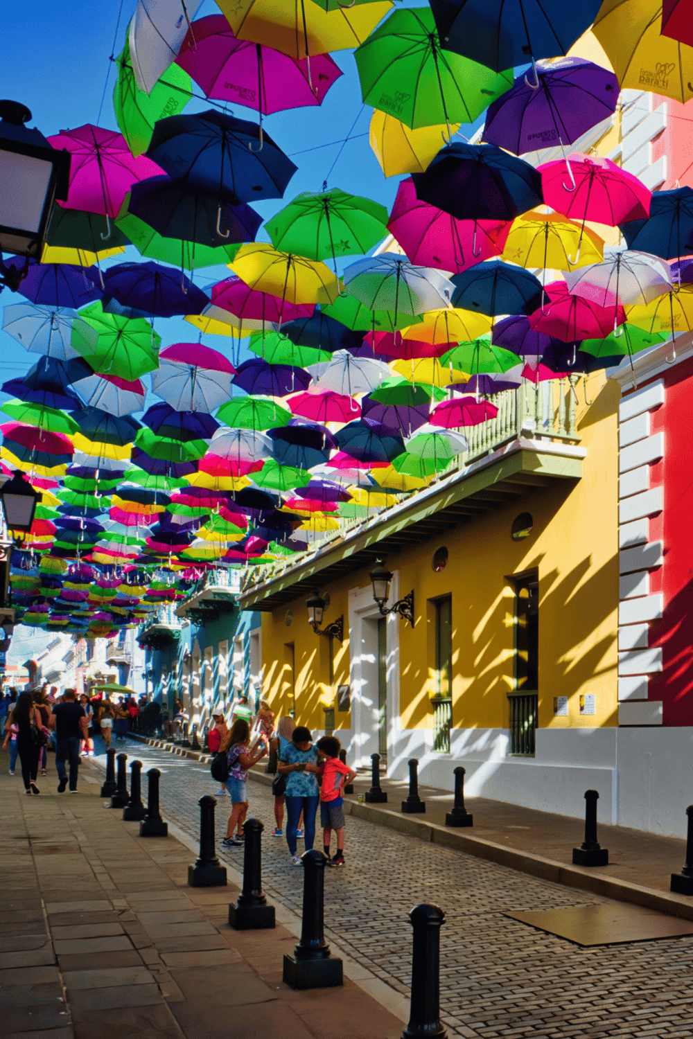 Colorful umbrella street art in Puerto Rico, vibrant tourist destination with scenic views.